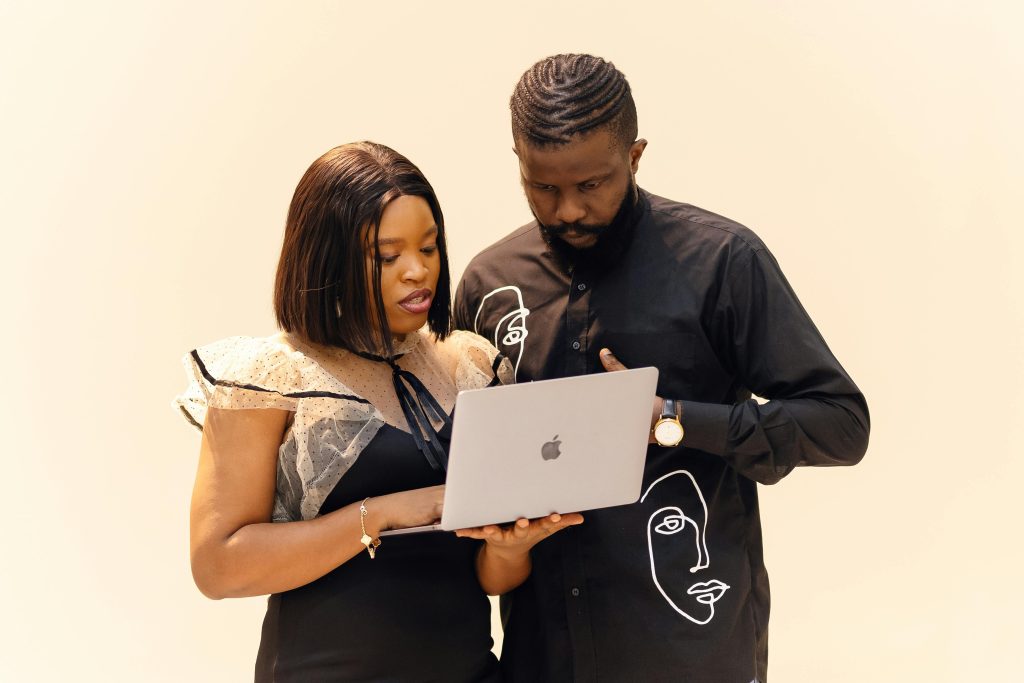 pexels photo 30678212 30678212 1 Two professionals working together on a laptop, showcasing teamwork in a modern office setting.