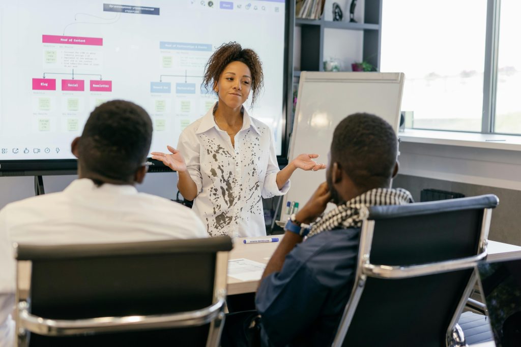 pexels photo 9301156 9301156 A woman leads a team meeting in a modern office using digital presentations.